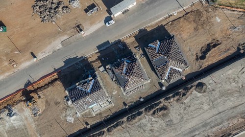 Drone aerial view of home construction site early stage