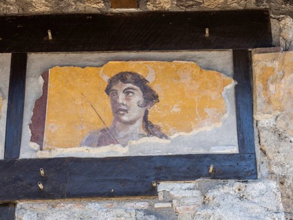 Painted head of a patron god