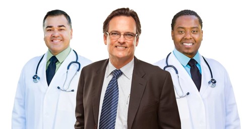 Two mixed-race doctors behind businessman isolated on a white background