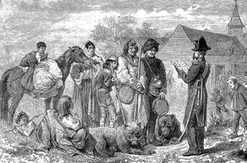 A group of gypsies is stopped and controlled by the village policeman