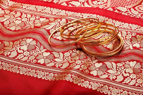 Indian sari with golden bangles clouse up