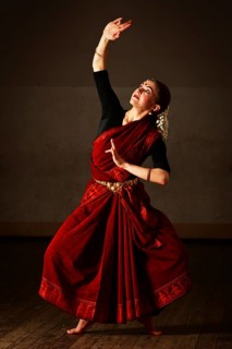 Young woman in sary dancing classical traditional indian dance Bharat Natyam