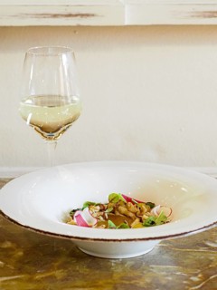 Macro close up of atlantic squid plated with potato rich sauce cream reduction