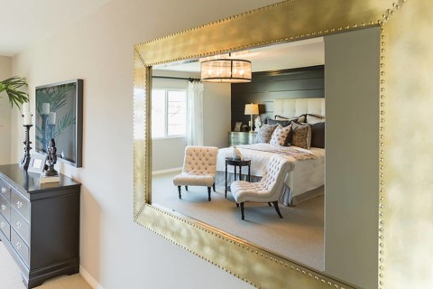 Beautiful bedroom reflection in decorative mirror