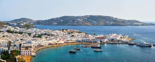 View of Mykonos town Greek tourist holiday vacation destination with famous windmills