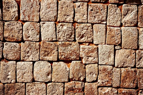Texture of stone wall of ancient Mayan pyramids in Uxmal