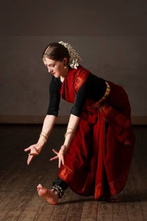 Young woman in sary dancing classical traditional indian dance Bharat Natyam