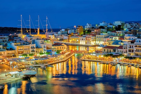 Beautiful Agios Nikolaos town on lake Voulismeni at night. Lasithi region of Crete island