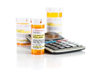 Calculator and non-proprietary medicine prescription bottles isolated on a white background