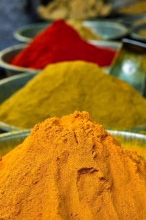 Turmeric curcuma powder and chili powder in spices market in India. Sardar Market