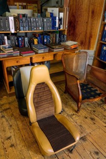 Antique chair and car seat in a saddlery in Allgaeu