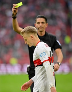 Referee Deniz Aytekin shows yellow card to Chris Fuehrich VfB Stuttgart