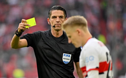 Referee Deniz Aytekin shows yellow card to Chris Fuehrich VfB Stuttgart
