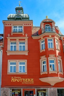 Red classicist facade with bay window