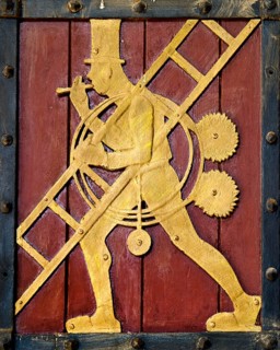 Historic figure on the door to the Ratskeller representing the craft of the chimney sweep