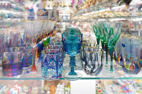 Colourful drinking glasses made in Murano on display in a shop in Venice