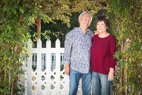 Attractive happy chinese couple enjoying their house outside