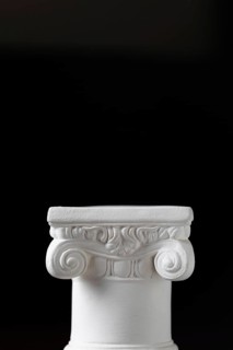 White ionic design column on dark background