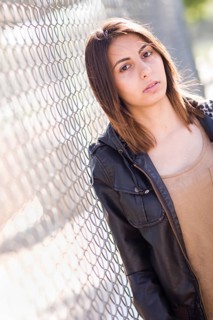 Beautiful meloncholy mixed-race young woman portrait outside
