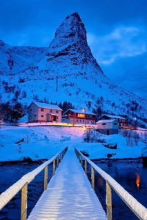 Bridge in Reine village covered with snow at night. Lofoten islands