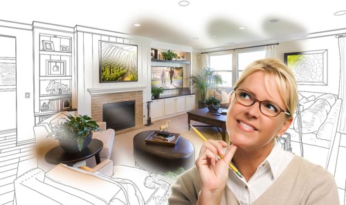 Woman with pencil over living room design drawing and photo combination