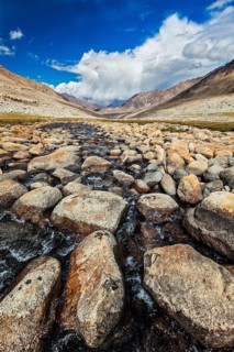 Mountain stream with stones in Himalayas near Khardung La pass. Ladakh