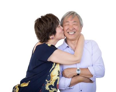 Attractive affectionate senior chinese couple isolated on a white background