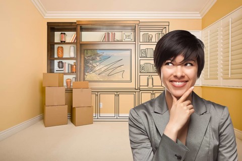 Young mixed-race female looking to the side in room with drawing of entertainment unit on wall