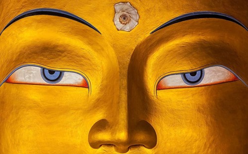 Eyes of Maitreya Buddha face close up. Thiksey Gompa. Ladakh