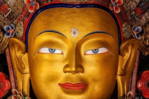 Maitreya Buddha statue face close up in Thiksey Gompa. Ladakh