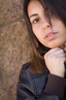 Beautiful meloncholy mixed-race young woman portrait outside