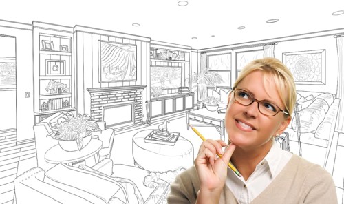Woman with pencil over custom living room design drawing