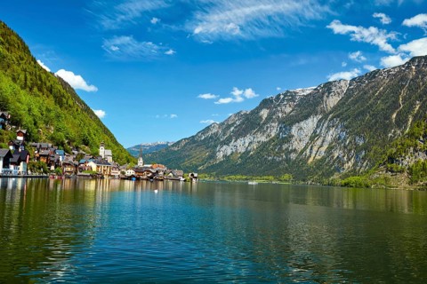 Swan in lake against Hallstatt village on Hallstatter See in Austrian alps. Salzkammergut region