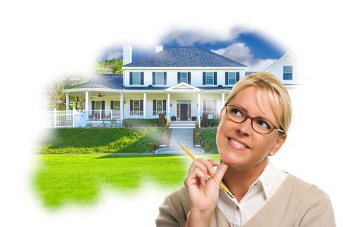 Daydreaming woman with pencil over custom house photo in thought bubble