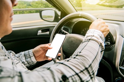 Man using his phone while driving