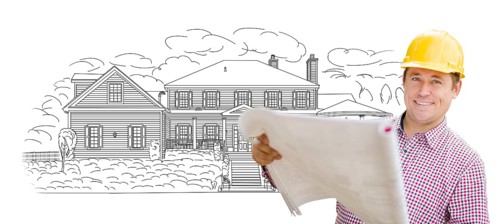 Smiling contractor holding blueprints over custom home drawing