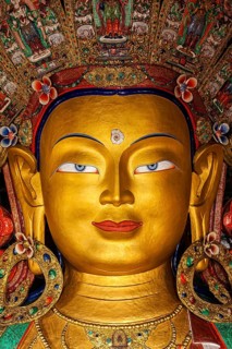 Maitreya Buddha statue face close up in Thiksey Gompa. Ladakh
