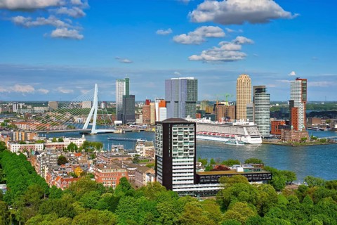 View of Rotterdam city and the Erasmus bridge Erasmusbrug over Nieuwe Maas river with cruise liner from Euromast