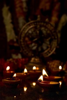 Diwali lights oil candles with Shiva Nataraja in the background for Maha Shivaratri