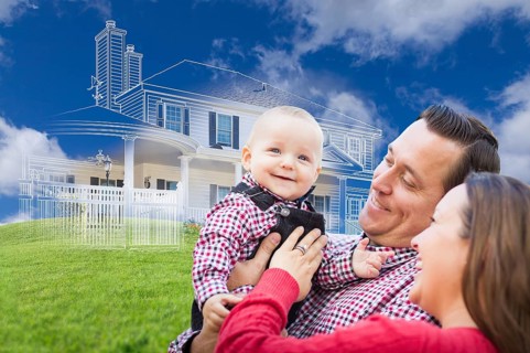 Happy young family with ghosted house drawing