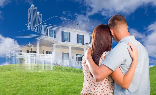 Young military couple facing ghosted house drawing