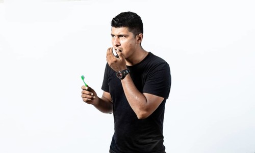 Man with brush and bad breath