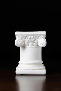 White ionic design column on dark background