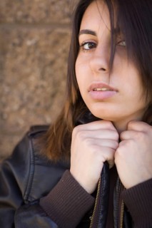 Beautiful meloncholy mixed-race young woman portrait outside