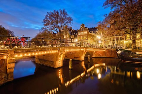 Night view of Amterdam cityscape with canal
