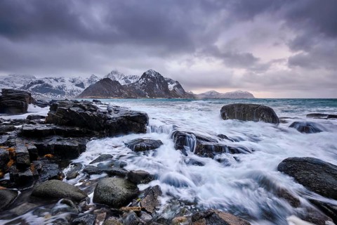 Rocky coast of fjord of Norwegian sea in winter. Vareid