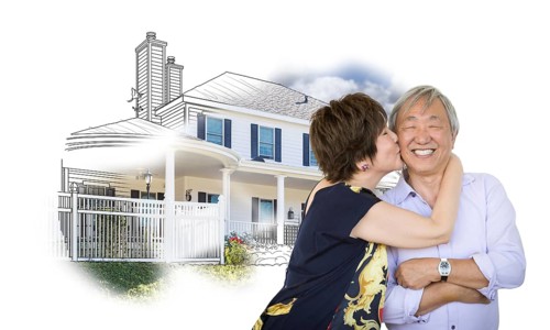 Happy chinese senior couple kissing in front of house drawing on white