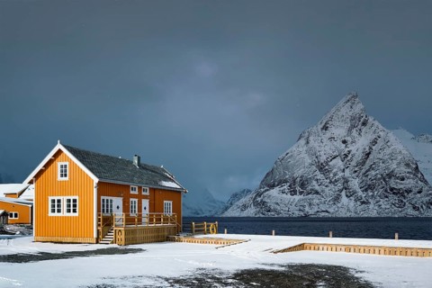 Yellow traditional rorbu house in Sakrisoy fishing village in winter on Lofoten Islands