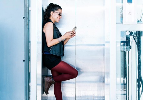 A person texting in the elevator