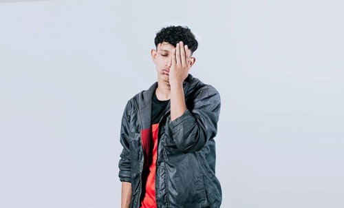 Tired and distressed people covering his face with his palm
